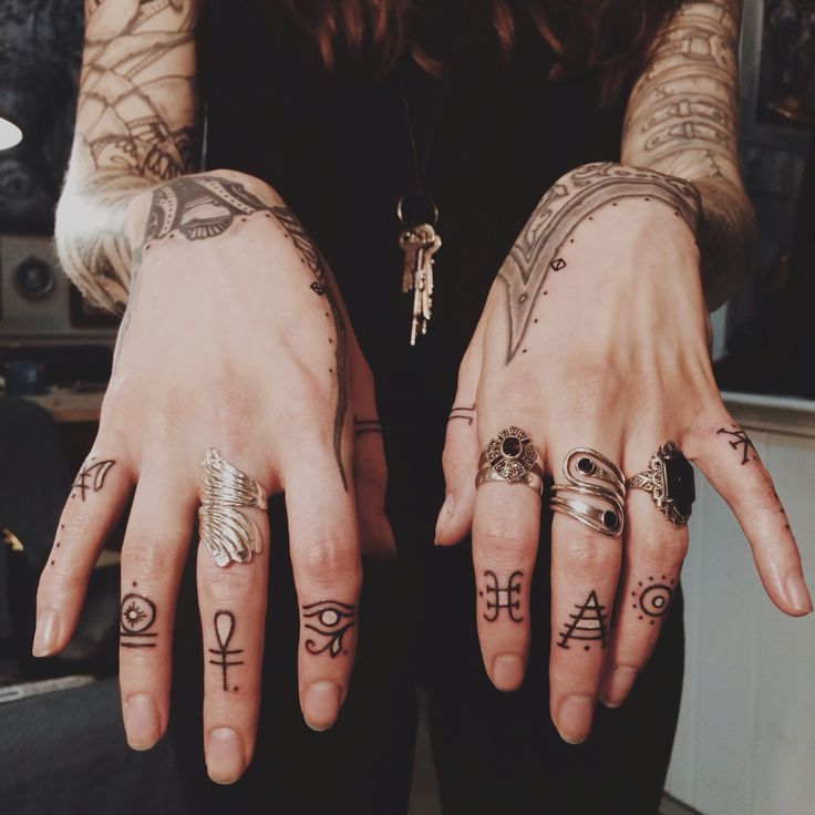 two hands with different tattoos on them