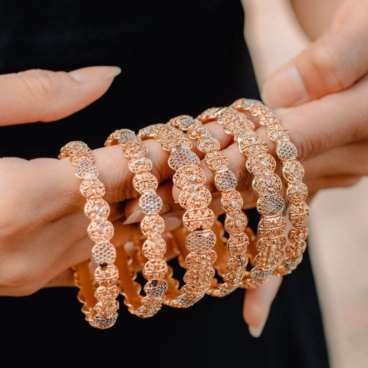 A minimal design embellished with luminous crystals! Beautiful bangles displaying intricate metal work and encrusted with shimmering stones. Available in various sizes. Designed over high-quality brass as the base metal with gold and rhodium polish. Size 2.2, 2.6 & 2.10 are in-stock & ready-to-ship. Delivery time frame for Size 2.4, 2.5 & 2.8 is 4-6 weeks. For custom or urgent requests, please contact support@alacouture.com. *Please Note: We use faux stones and beads in all of our jewelry. Rose Gold Metal Bangle For Wedding, Gold Fusion Bangle With Intricate Design, Traditional Gold Bangle With Diamond Accents, Hand Set Metal Bangle For Parties, Glamorous Metal Bangle Jewelry, Fusion Style Metal Bangle Jewelry, Hand-set Metal Bangle For Parties, Rose Gold Bangle With Diamond Accents, Glamorous Metal Bangle