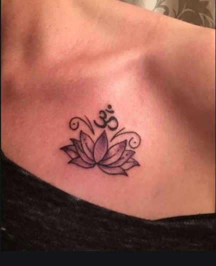 a woman's chest with a lotus tattoo on it