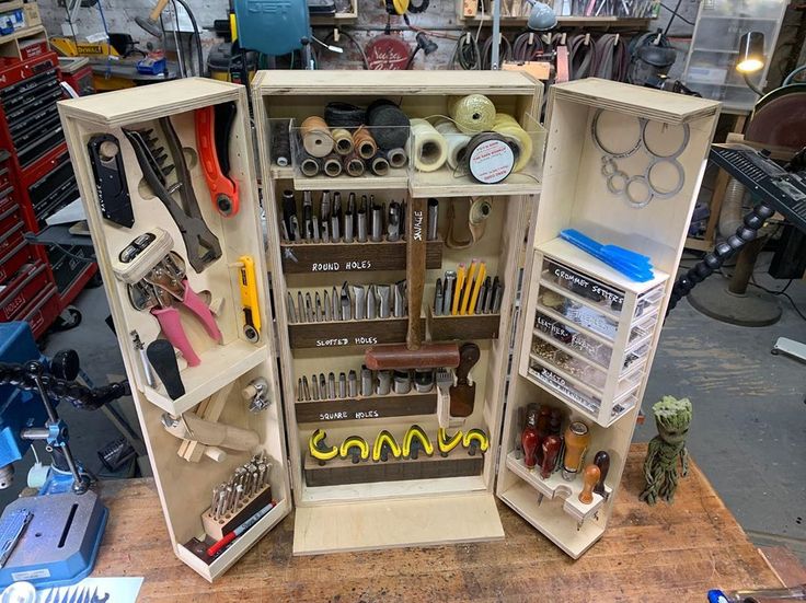 an open cabinet filled with lots of tools