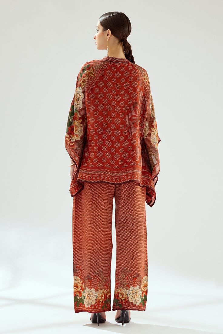 Rust poncho tunic with mandarin collar, beaded sleeves hem and front tie-up.
Components: 1
Type Of Work: Floral, Geometric
Neckline: Mandarin
Sleeve Type: Flared
Fabric: Silk
Color: Orange
Other Details: 
Note: Pant, bag shown in the image is not for sale
Occasion: Work - Aza Fashions Silk Poncho, Rajdeep Ranawat, Beaded Sleeves, Tunics Online, Floral Geometric, Fabric Silk, Not For Sale, Mandarin Collar, Aza Fashion