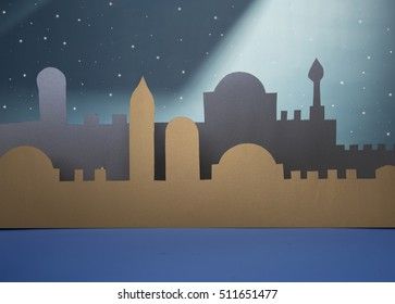 an image of a night scene with the city skyline cut out from cardboard and placed on a wall