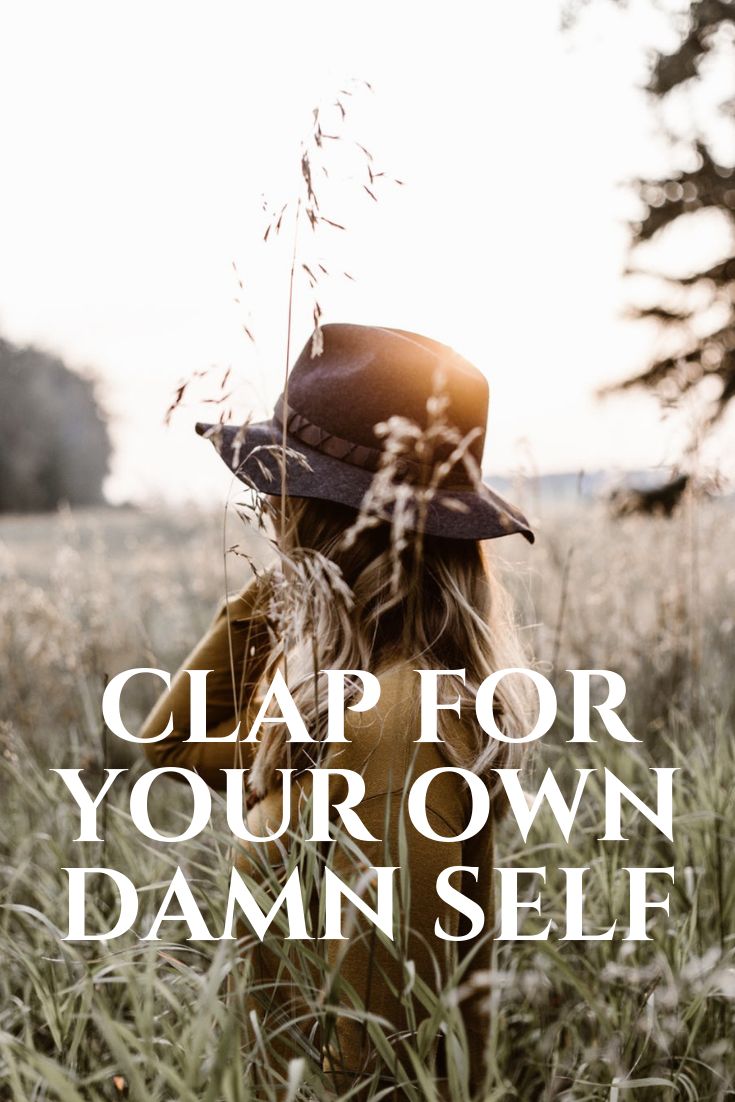 a woman standing in tall grass with the words clap for your own damn self