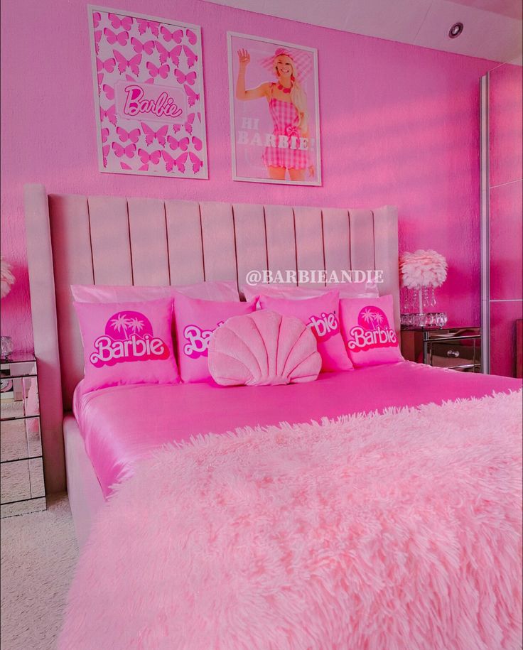 a bedroom with pink bedding and pictures on the wall above it that says barbie