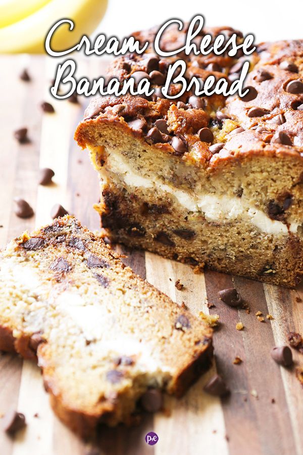 a loaf of cream cheese banana bread on a cutting board with chocolate chips around it