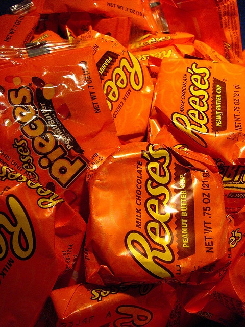 a pile of orange bags filled with reese's