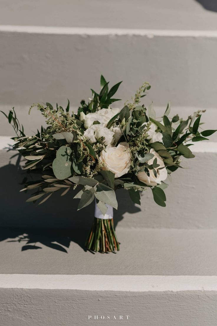 a bridal bouquet sitting on the steps