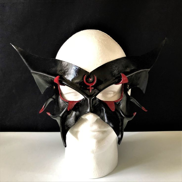 DESCRIPTIONCosPlay the Greek God of War, God of the Underword, or a Demonic entity. Airbrushed in black with red detailing. Use this costume accessory for demon LARP, Halloween party, circus, Renaissance Faire, parade, add to a Carnival Costume! Awesome for Halloween, Cosplay conventions, Renaissance Faire, SCA, Greek God Cosplay. Any color. Waterproofed leather, glossy or matte finish, & several choices to affix the mask (cord, elastic, ribbon, waterproof cord, stick, or no holes for adhesi Gothic Horned Masks For Fantasy Events, Gothic Masks And Prosthetics For Carnival Fantasy Events, Gothic Masks And Prosthetics For Carnival, Black Gothic Cosplay Costume For Costume Party, Black Gothic Festival Costume, Gothic Mask Costume Accessories For Fantasy Events, Gothic Mask For Fantasy Events, Gothic Masks And Prosthetics For Halloween Cosplay, Gothic Costume Accessories For Masquerade And Cosplay Events