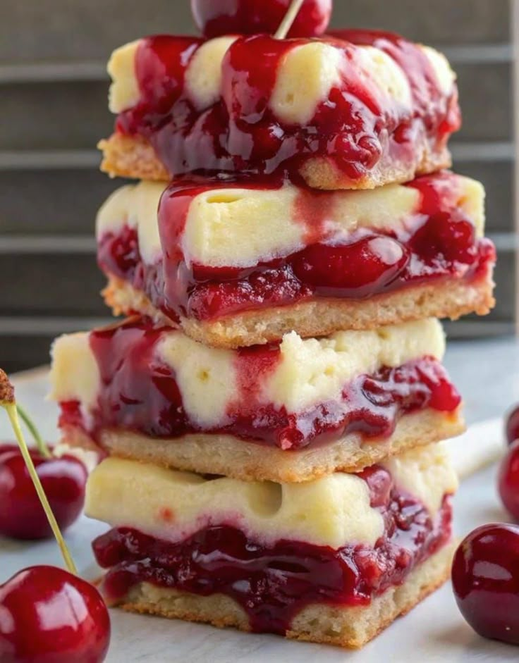 cherry cheesecake bars stacked on top of each other