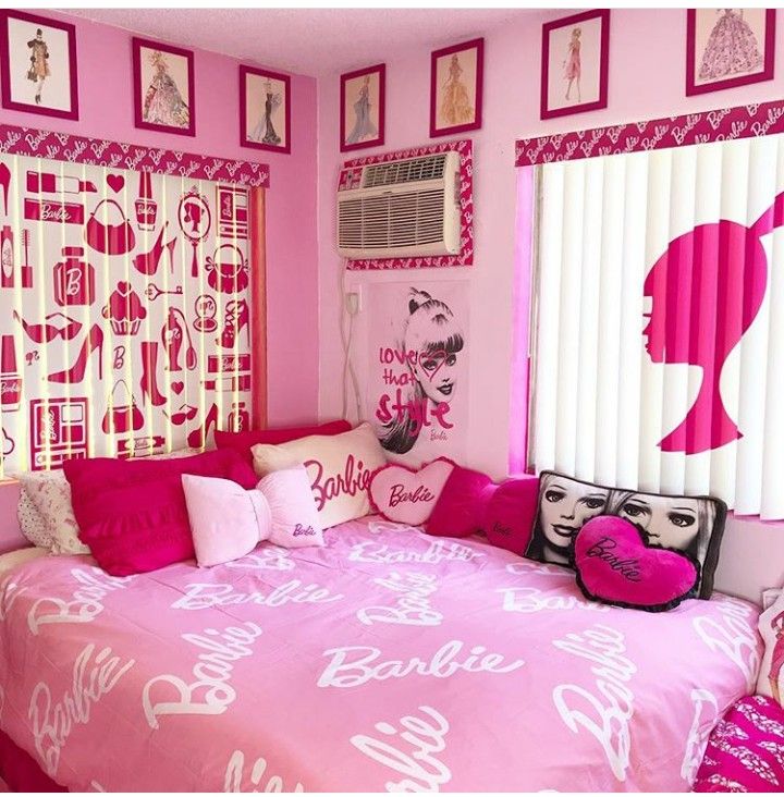 a bedroom decorated in pink and white with pictures on the wall