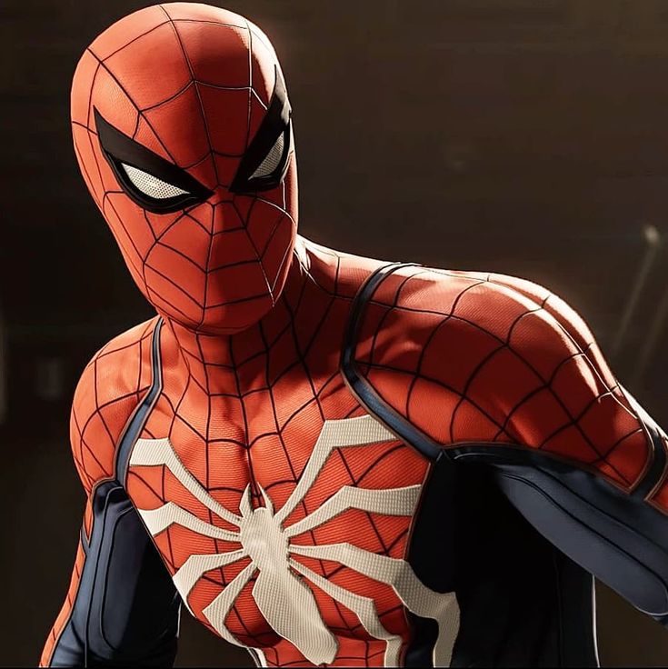 a close up of a spider - man in an orange and black suit with his hands on his hips