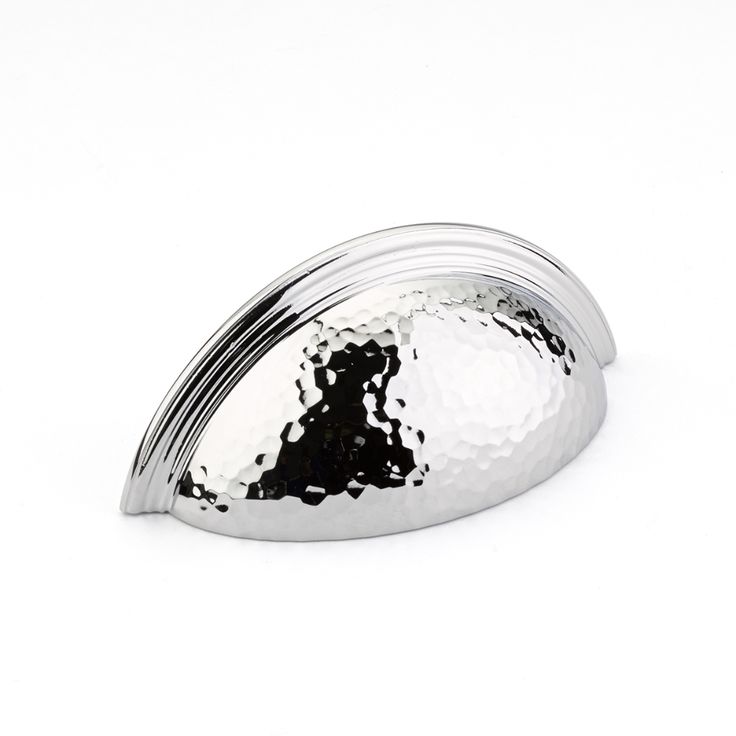 a shiny metal object on a white background