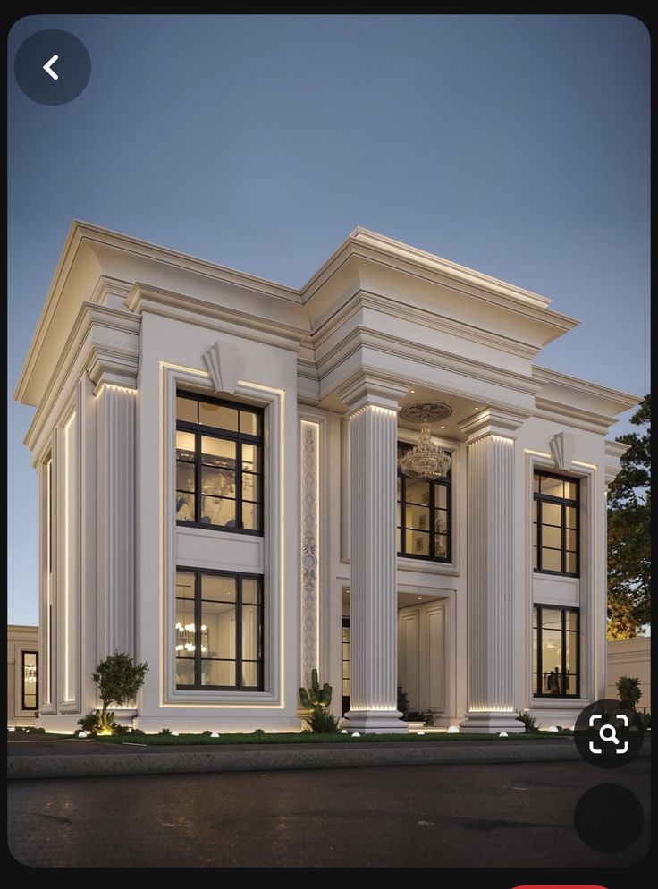 a large white building with columns on the front and windows in the middle, at night