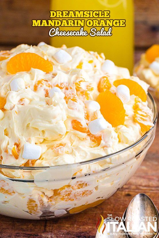 a close up of a bowl of food with oranges and marshmallows