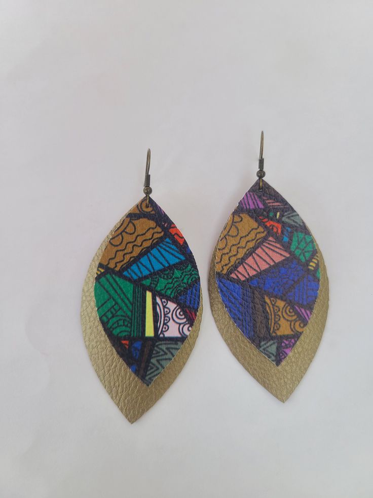 This product is a 3-inch, colorful tribal pattern on a shiny brown earring with antique gold hooks. Great for a gift! Comes from a smoke free home. Shipping is around 2-3 days, but usually ships more quickly.   Please ensure your address is correct before purchasing. We will ship to the address provided at checkout and we are not responsible for products shipped to the wrong address. Thank you! Artsy Brown Earrings With Ear Wire, Brown Dangle Earrings With Artsy Style, Artsy Multicolor Nickel Free Earrings, Nickel-free Multicolor Artsy Earrings, Artsy Multicolor Nickel-free Earrings, Artsy Brown Drop Earrings, Brown Artsy Earrings, Hand Painted Multicolor Earrings For Party, Multicolor Hand Painted Drop Earrings