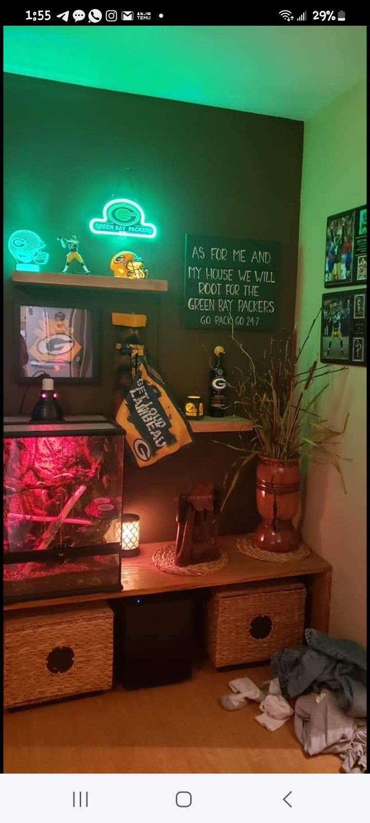 a desk with two drawers and some plants on it in front of a chalkboard