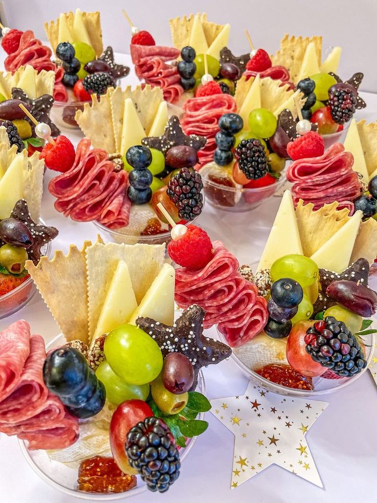 an arrangement of fruit and crackers arranged in the shape of a star on a table