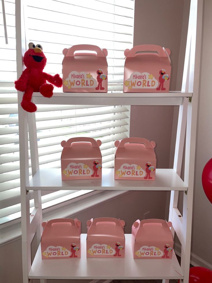 the shelves are filled with pink plastic containers and stuffed animals, including a red teddy bear