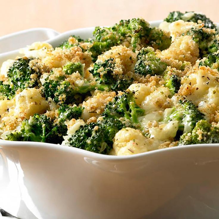 broccoli and cauliflower casserole in a white dish on a table