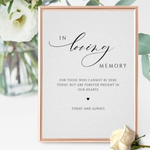 a card with the words in loving memory on it next to some flowers and greenery