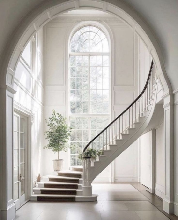 a staircase leading up to a large window