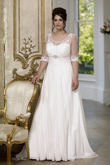 a woman in a white dress standing next to a chair