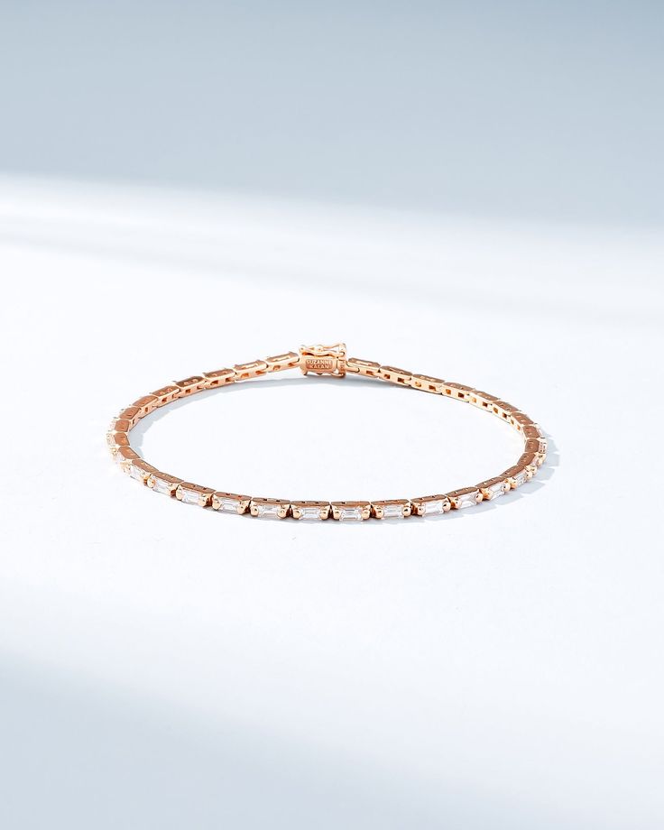 Crafted with 18-karat gold, this piece showcases baguette white diamonds in a horizontal design to maximize their brilliance with every movement. It is elegant and slender which offers versatility, making it a suitable and subtle addition to any outfit. Details 18k yellow gold, rose gold or white gold 1.75 carats of baguette white diamonds Bracelet measures 7" inches in length Box clasp with safety lock fastening 2mm width Ref: AKB574D Modern Diamond Bracelet With Baguette Cut Accents, Modern Baguette Cut Diamond Bracelet With Accents, Modern Diamond Tennis Bracelet With Baguette Cut, Timeless Diamond White Tennis Bracelet With Baguette Cut, Luxury Diamond Tennis Bracelet With Channel Set, Emerald Cut Baguette Diamond Bracelets, Elegant Diamond Bracelet With Single Cut Emerald Shape, Elegant Diamond Bracelet With Emerald Cut Single Diamonds, Timeless Emerald Cut Diamond Bracelet With Baguette Diamonds