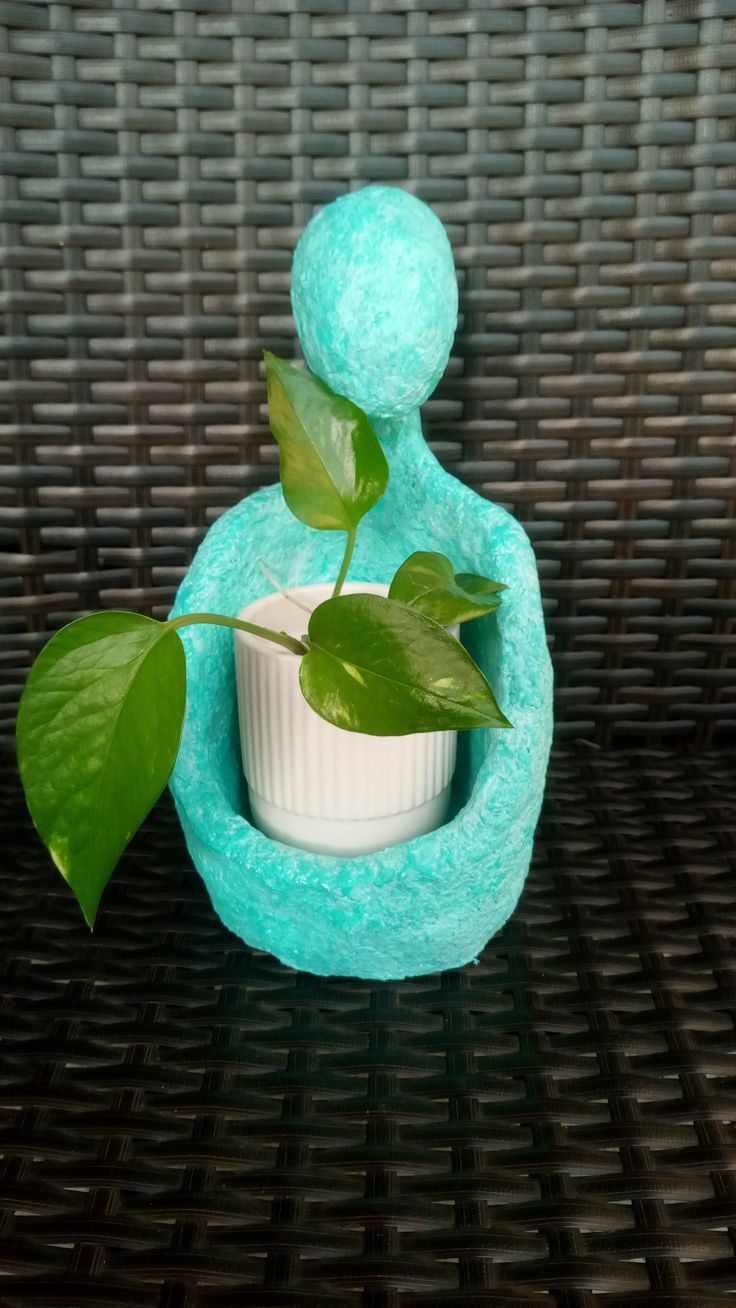 a small potted plant sitting inside of a blue vase