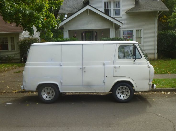 a white van parked in front of a house