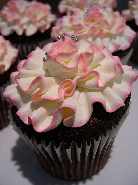 an image of cupcakes with pink and white frosting on them for sale