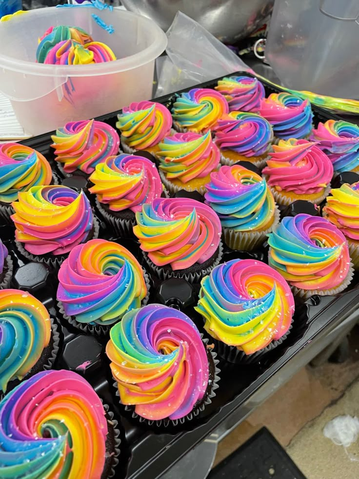 there are many cupcakes that have been made to look like rainbow swirls