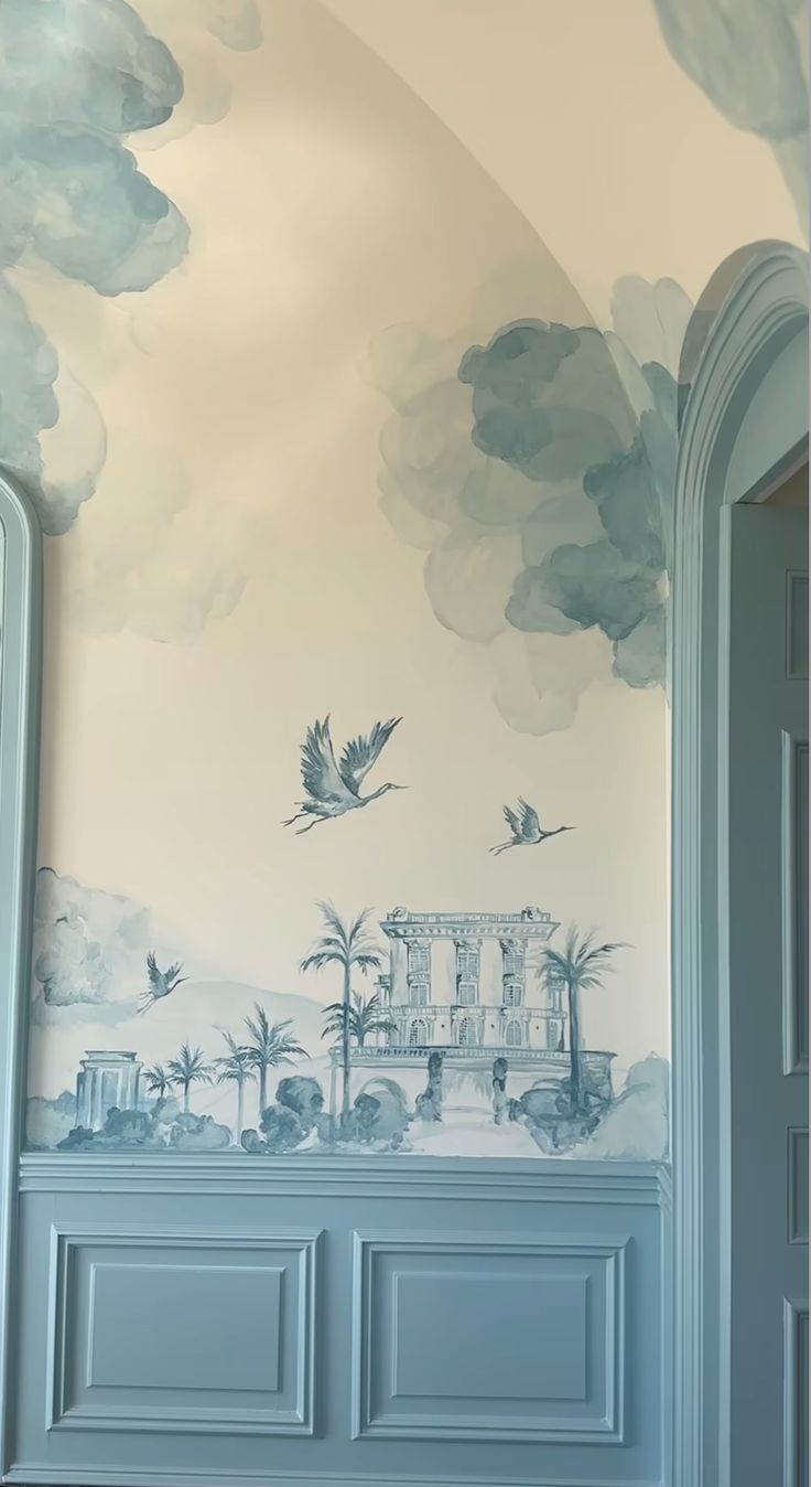 a room with blue walls and clouds painted on the wall