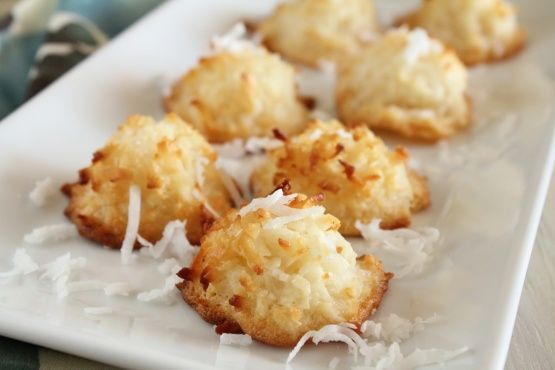 some food is on a white plate and has coconut flakes all over the top