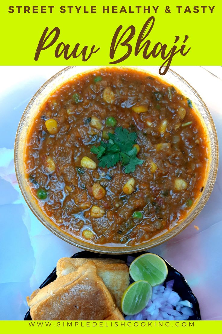 a bowl of stew with bread and cilantro garnish on the side