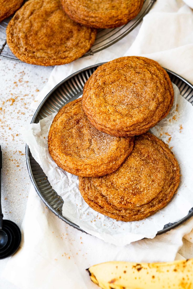 some cookies are on a plate next to bananas