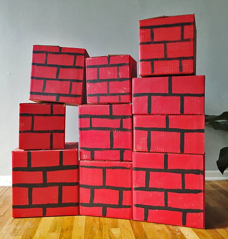 red bricks stacked on top of each other in the middle of a room with wood flooring