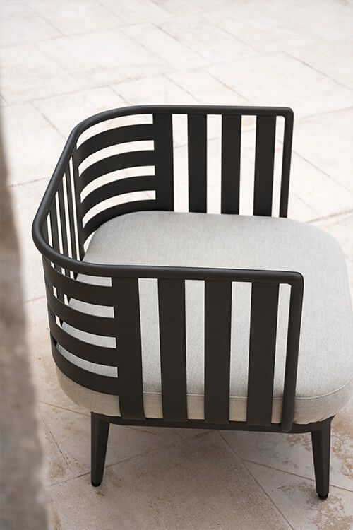 a black and white chair sitting on top of a tiled floor