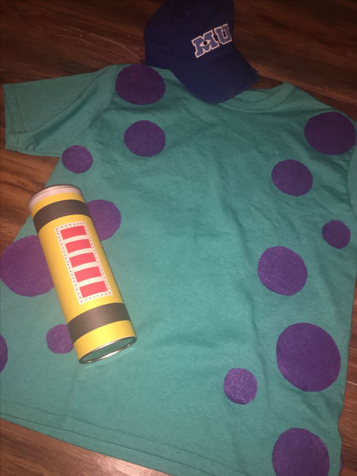 a green shirt with purple polka dots on it and a can of soda next to it