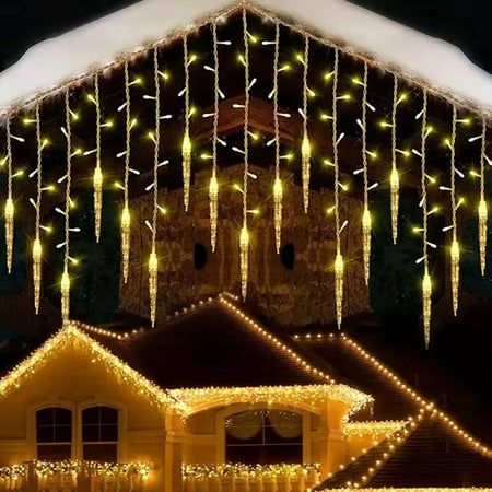 christmas lights are hanging from the roof of a house