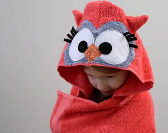 a child wrapped in a red towel with an angry bird on it's face