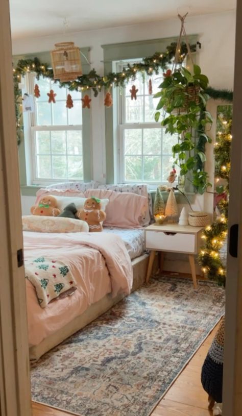 a bedroom decorated for christmas with garland and lights