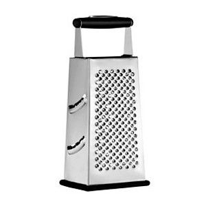 a white and black grater sitting on top of a metal container with handles to the side