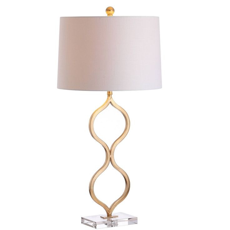 a gold lamp with a white shade on the base and a square shaped light fixture