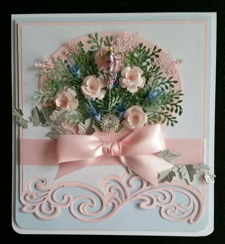 a card with flowers and ribbon on it