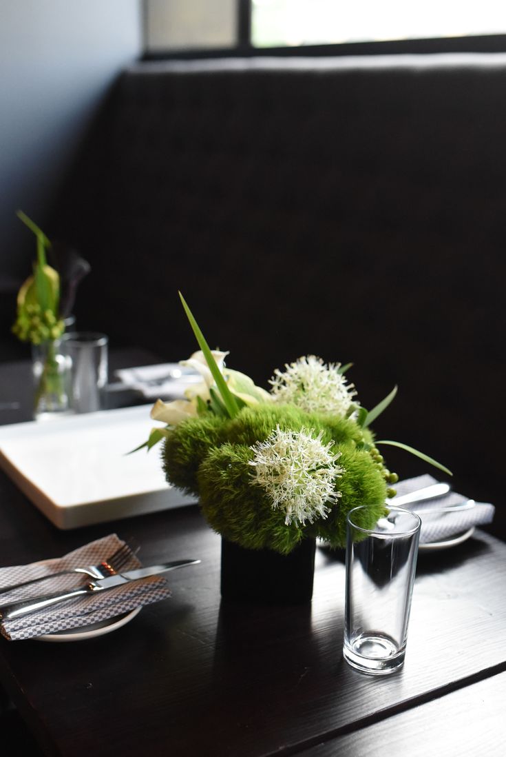 the table is set with flowers and silverware