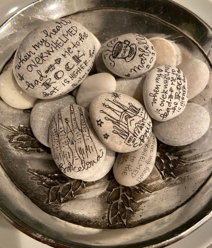 some rocks with writing on them in a bowl