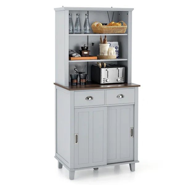 a kitchen cabinet with an open door and shelves on the top, next to a coffee maker