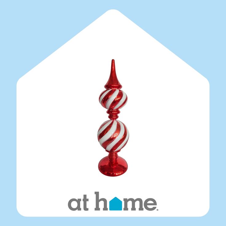 a red and white striped glass candle holder with the words athome on it