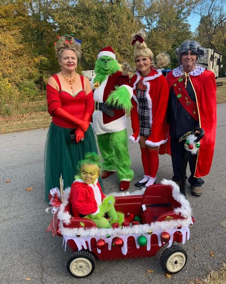 some people in costumes are posing for a photo with the grinen man and woman