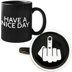 two black coffee mugs with white writing on them and one has a hand pointing towards the camera